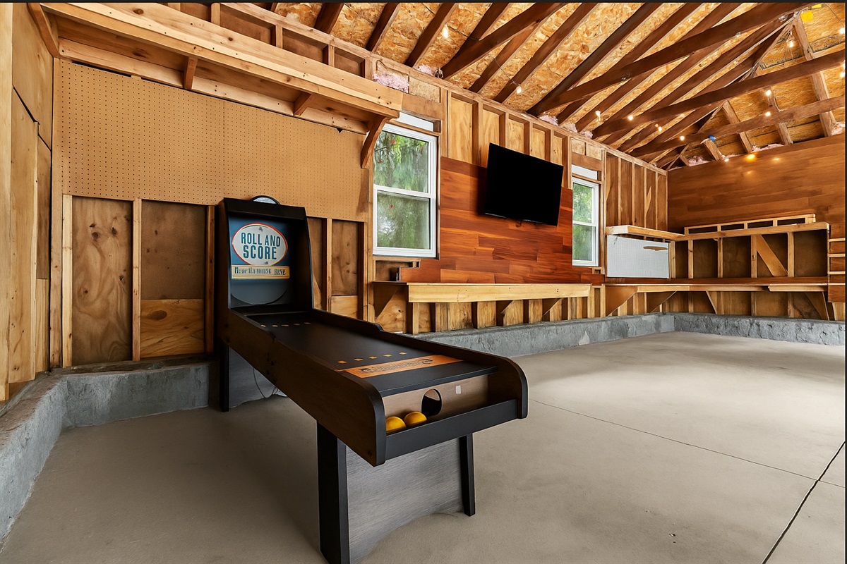 Garage game room with ski ball, TV, and plenty of space to hang out and unwind.