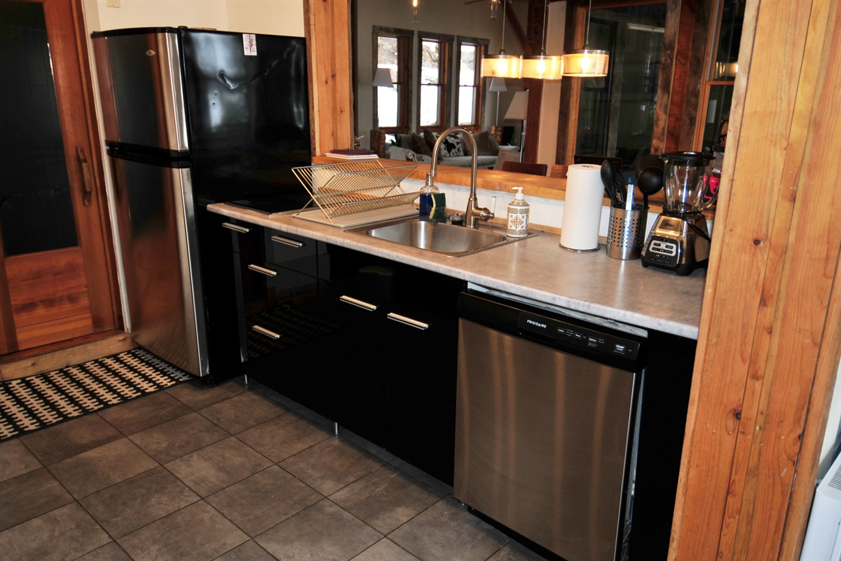 Kitchen layout showing dishwasher, sink and fridge