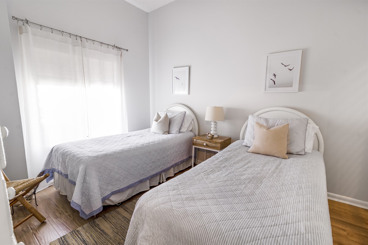 Bright and welcoming, the guest bedroom offers cozy accommodations perfect for family or friends, with easy access to a nearby full bathroom.
