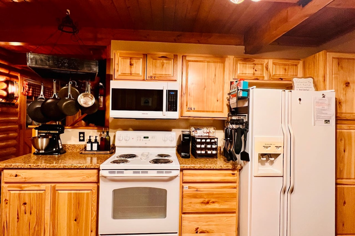 Main kitchen has 3 refrigerators, an eating area and is fully stocked with pots, pans, dishes and silverware.  It includes large and small cooking appliances and serving dishes of all sizes.