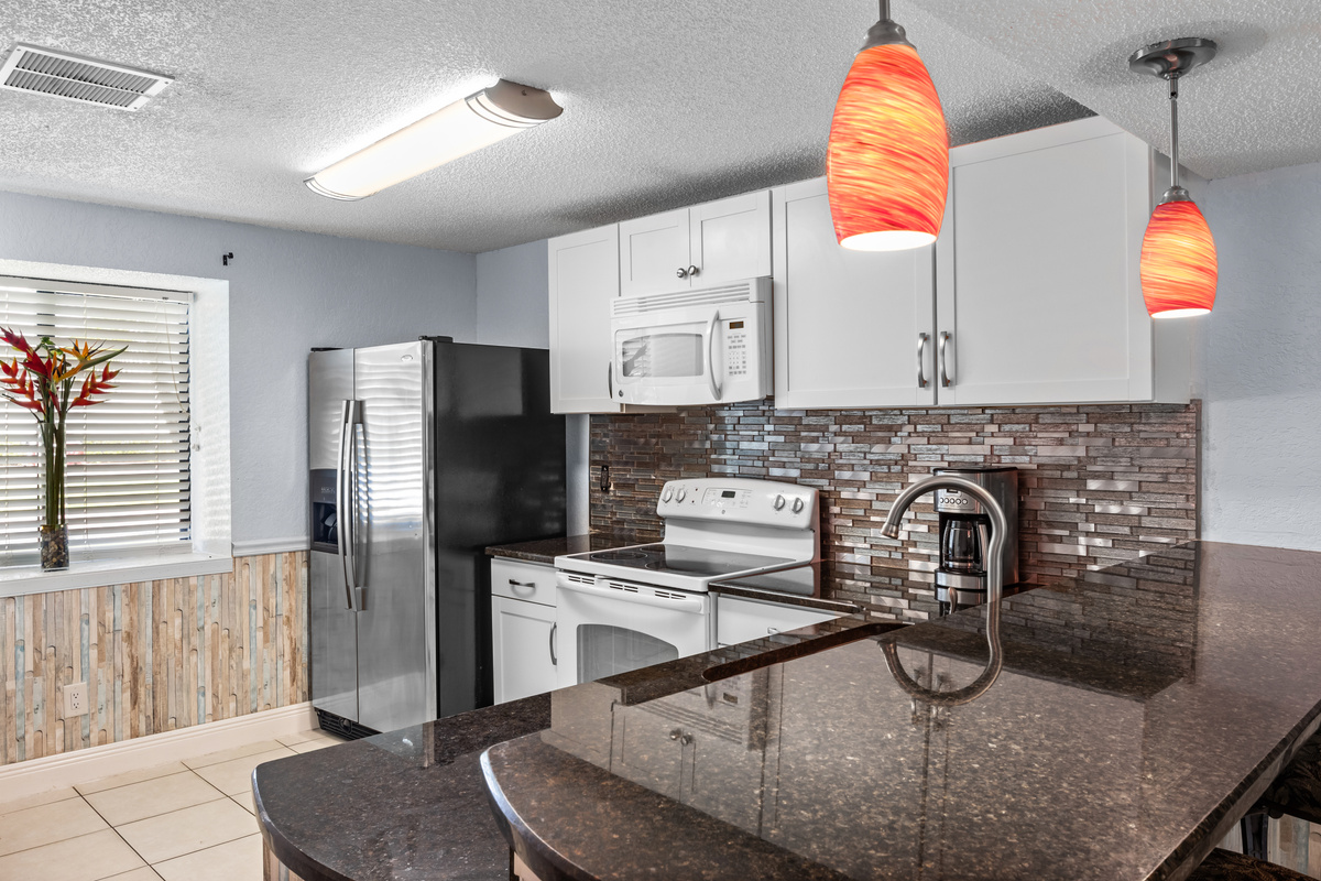 Kitchen. Natural light. Laundry room located in the kitchen including a washer and dryer machine.