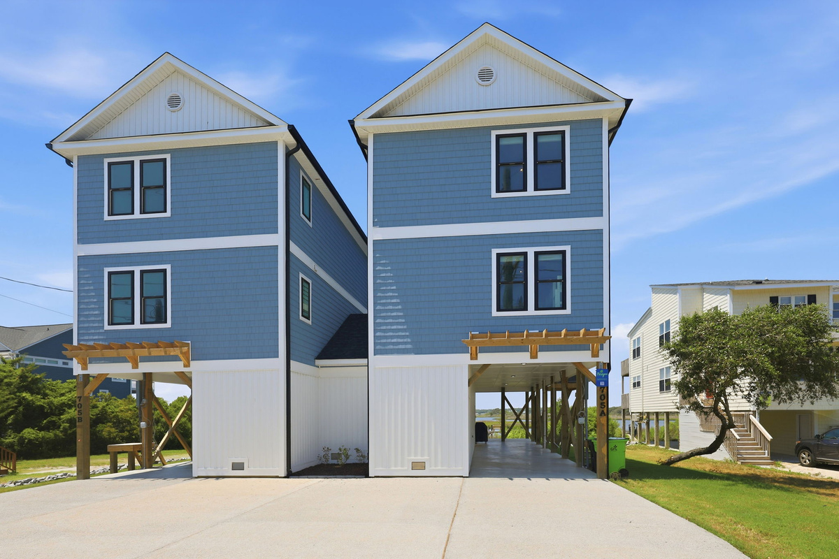 Welcome to this beautifully designed coastal retreat featuring covered parking, modern architecture, and easy beach access nearby
