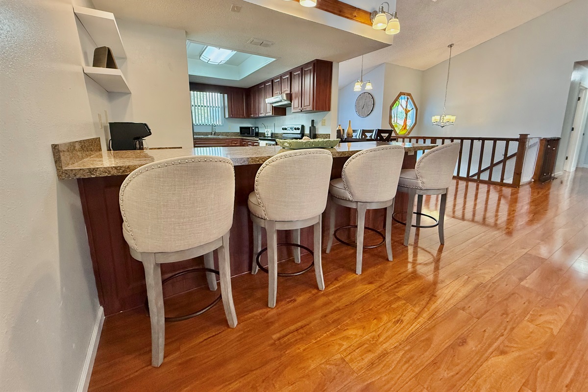 The extended countertops double as a bar, making this kitchen a great hub for casual dining, wine and cheese nights, or morning coffee chats.