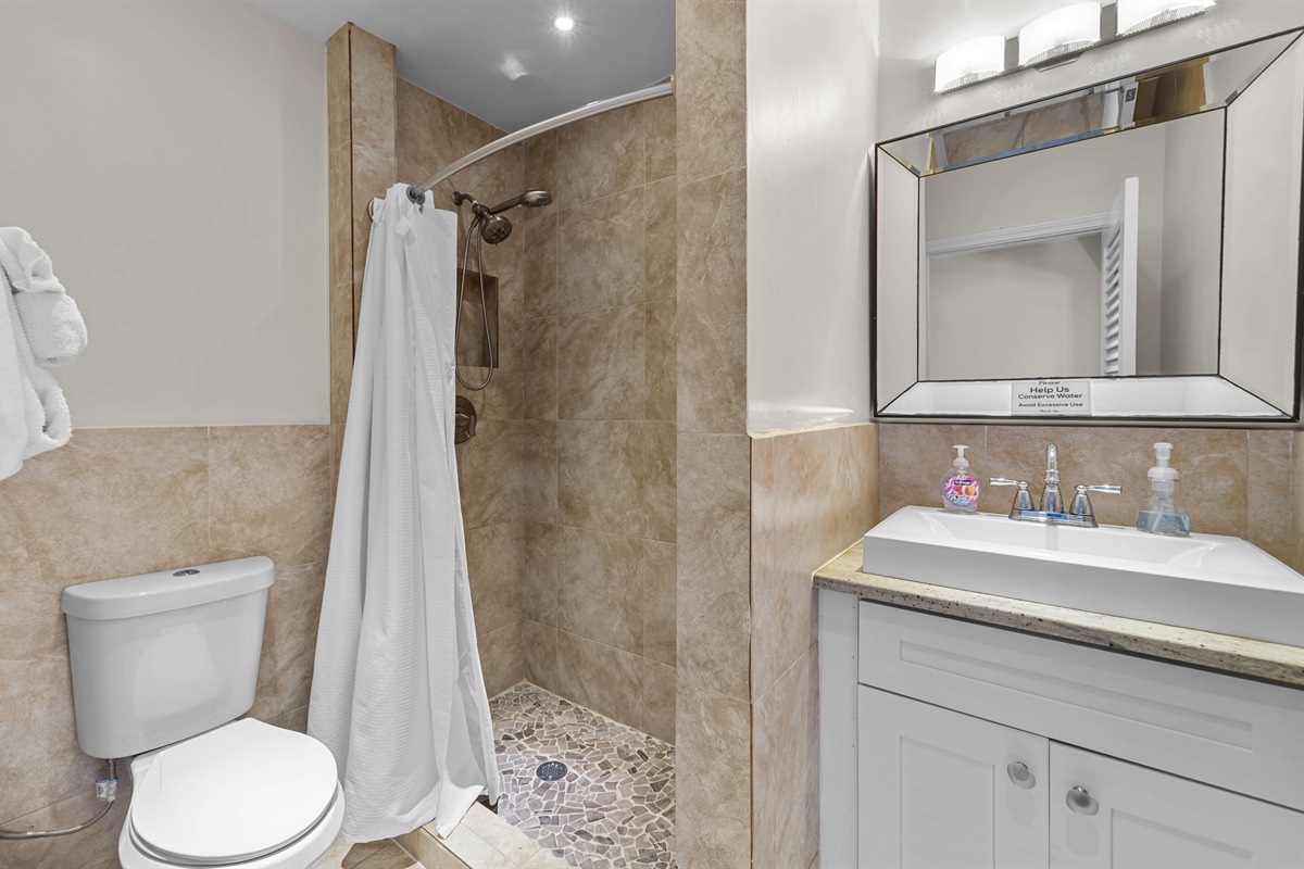 This remodeled bathroom is located between the two bedrooms