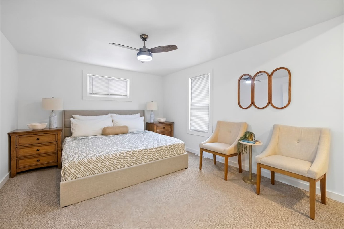 Master bedroom with a king sized bed. 