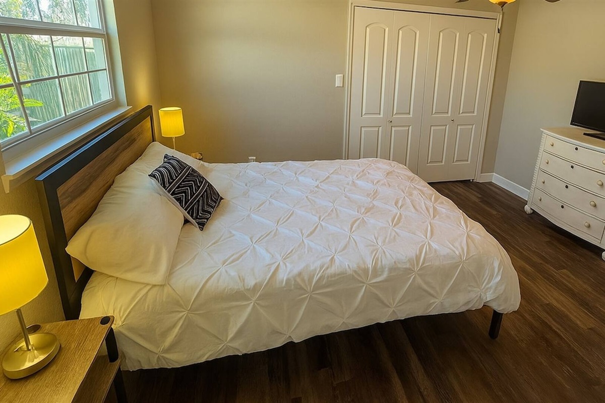 Bedroom 4 - Comfortable bedroom with queen bed, storage dresser, and natural window light