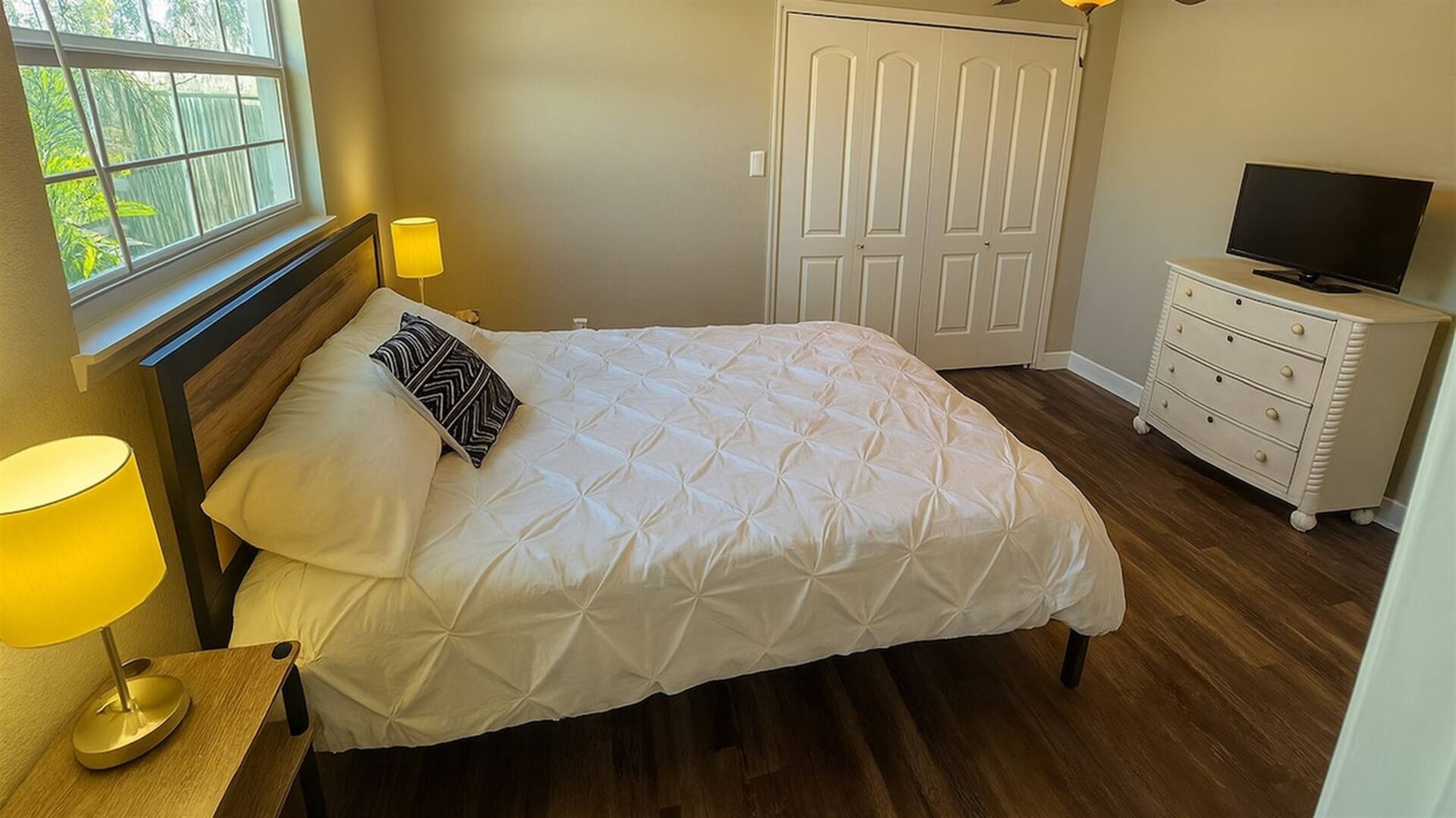 Bedroom 4 - Comfortable bedroom with queen bed, storage dresser, and natural window light