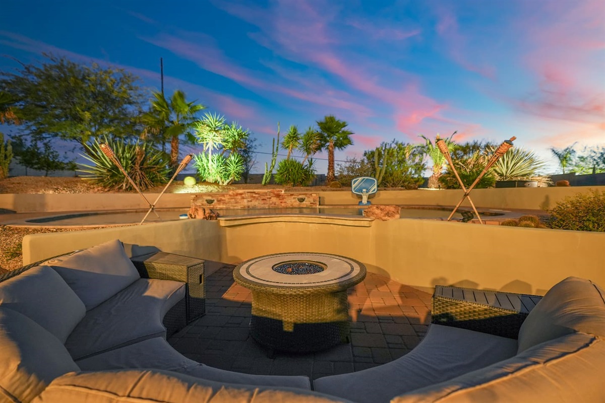Fire pit seating area overlooking the landscaped yard, perfect for gathering under the evening sky.