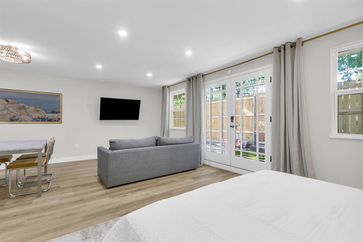 Experience this large 500 sq ft studio with an open layout, king bed, full kitchen, and cozy lounge area for relaxing or streaming your favorite shows.