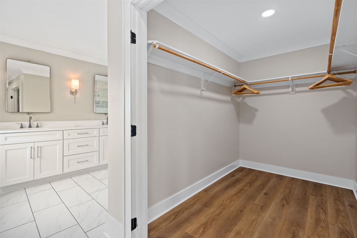 Spacious walk-in closet conveniently connected to the luxurious private master bathroom