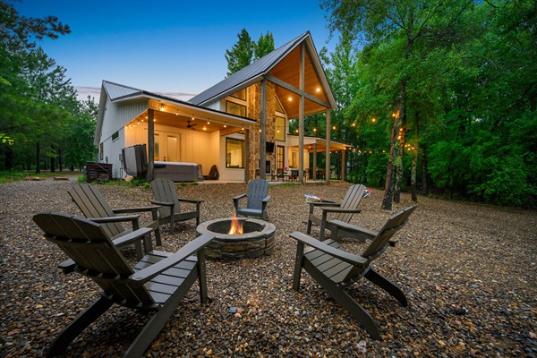 Unwind around the fire pit with friends or family under the glow of ambient lighting in this tranquil Creekside setting
