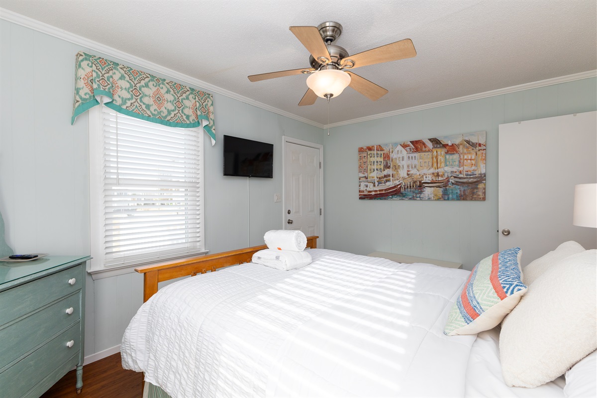 Inviting bedroom 2 with soft linens, ceiling fan, and Smart TV