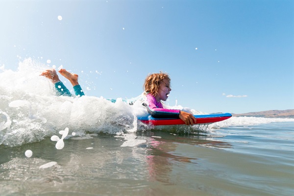 Boogie boarding brings big smiles and little thrills—just one more reason to love the beach life on 30A.