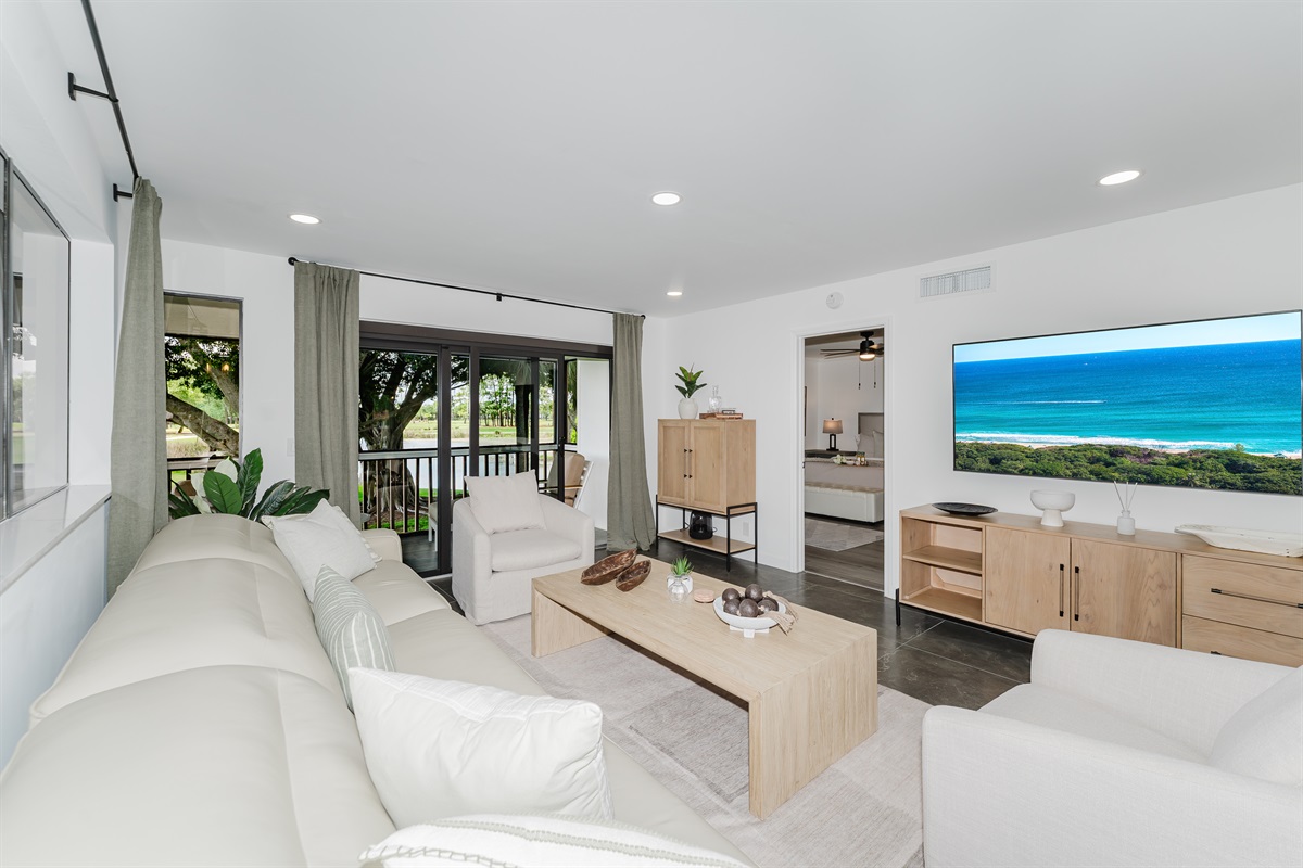 Seamless indoor-outdoor feel with large windows overlooking the fairway. Bright, open living space filled with natural light and golf course views. Comfortable seating is perfect for relaxing after a day at the beach or golf.