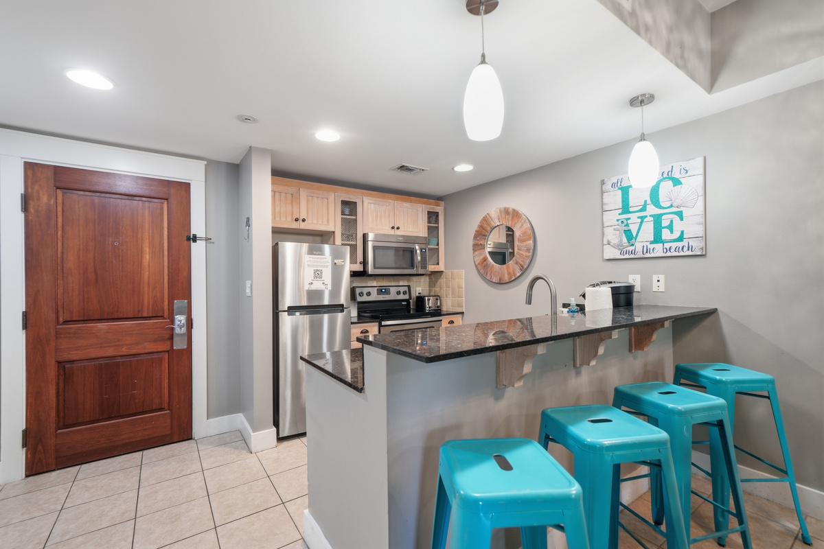 The kitchen is well-stocked with cooking utensils, pots & pans, and the bar has seating for four.