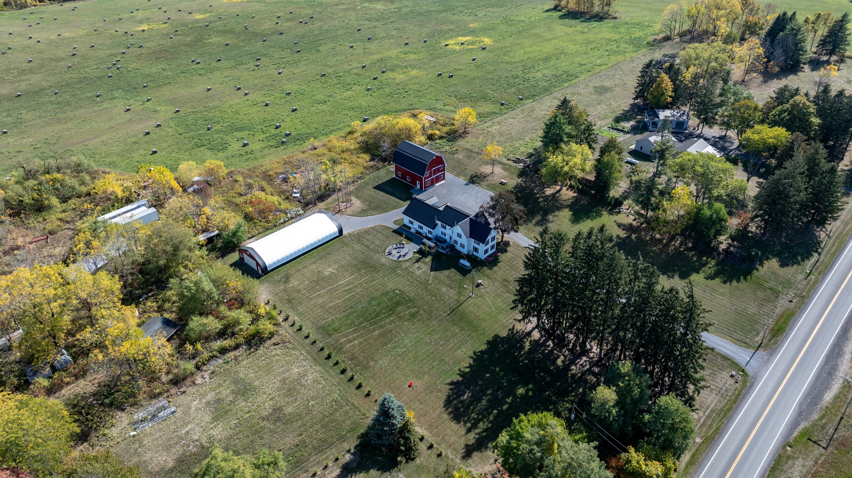 Classic red barn and cozy farmhouse set on acres of peaceful countryside in the Finger Lakes