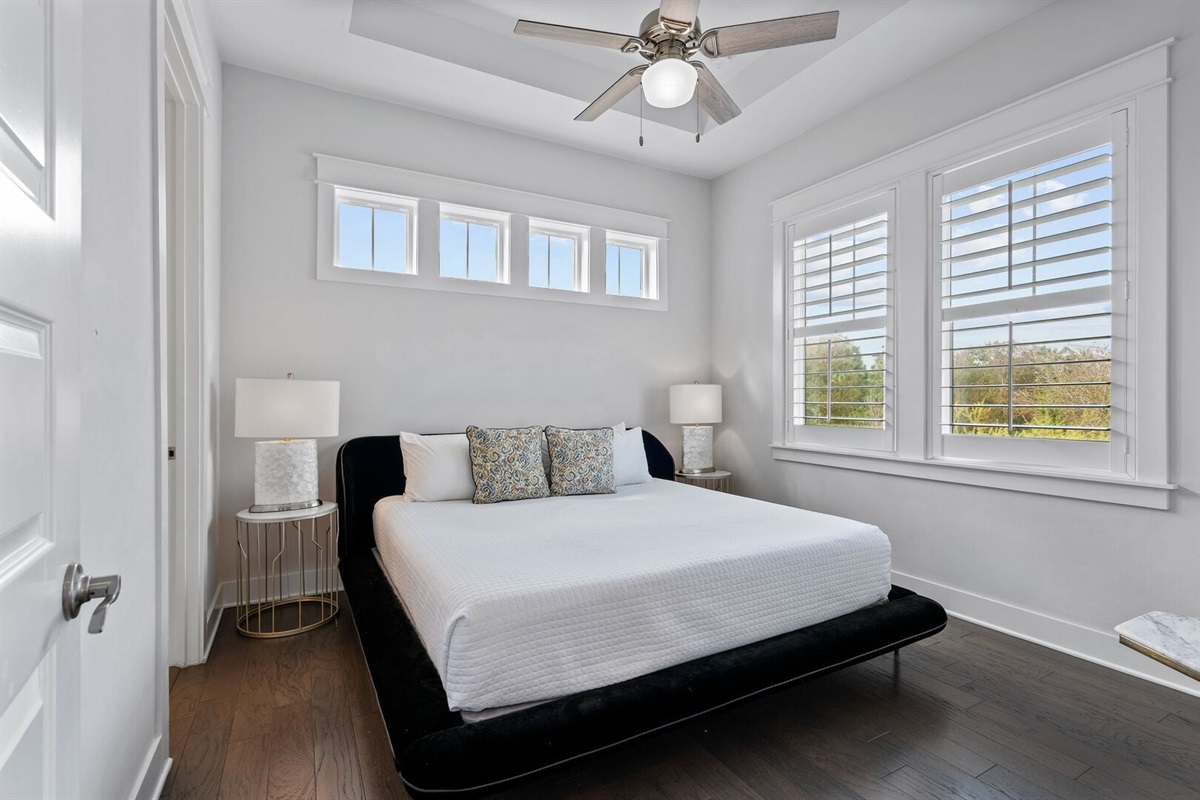 Modern guest bedroom with upholstered king bed.
