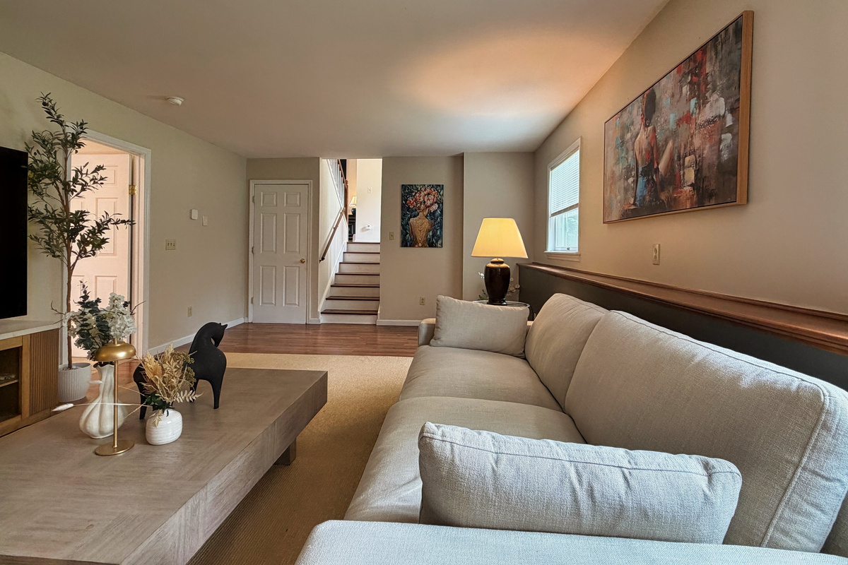Lower level living room with view of the stairs from the 1st floor
