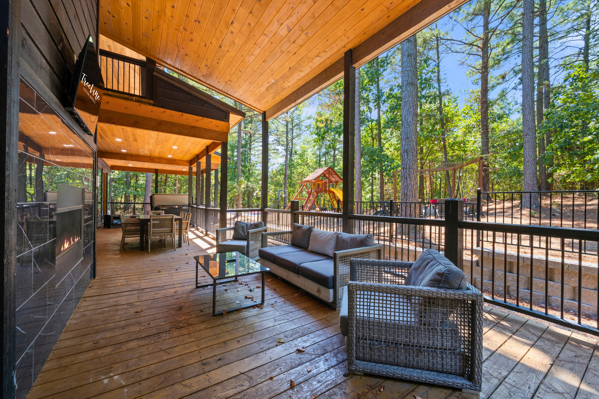 Settle into the comfortable outdoor seating and enjoy the wooded surroundings, with a covered deck that gives everyone plenty of room to relax together.