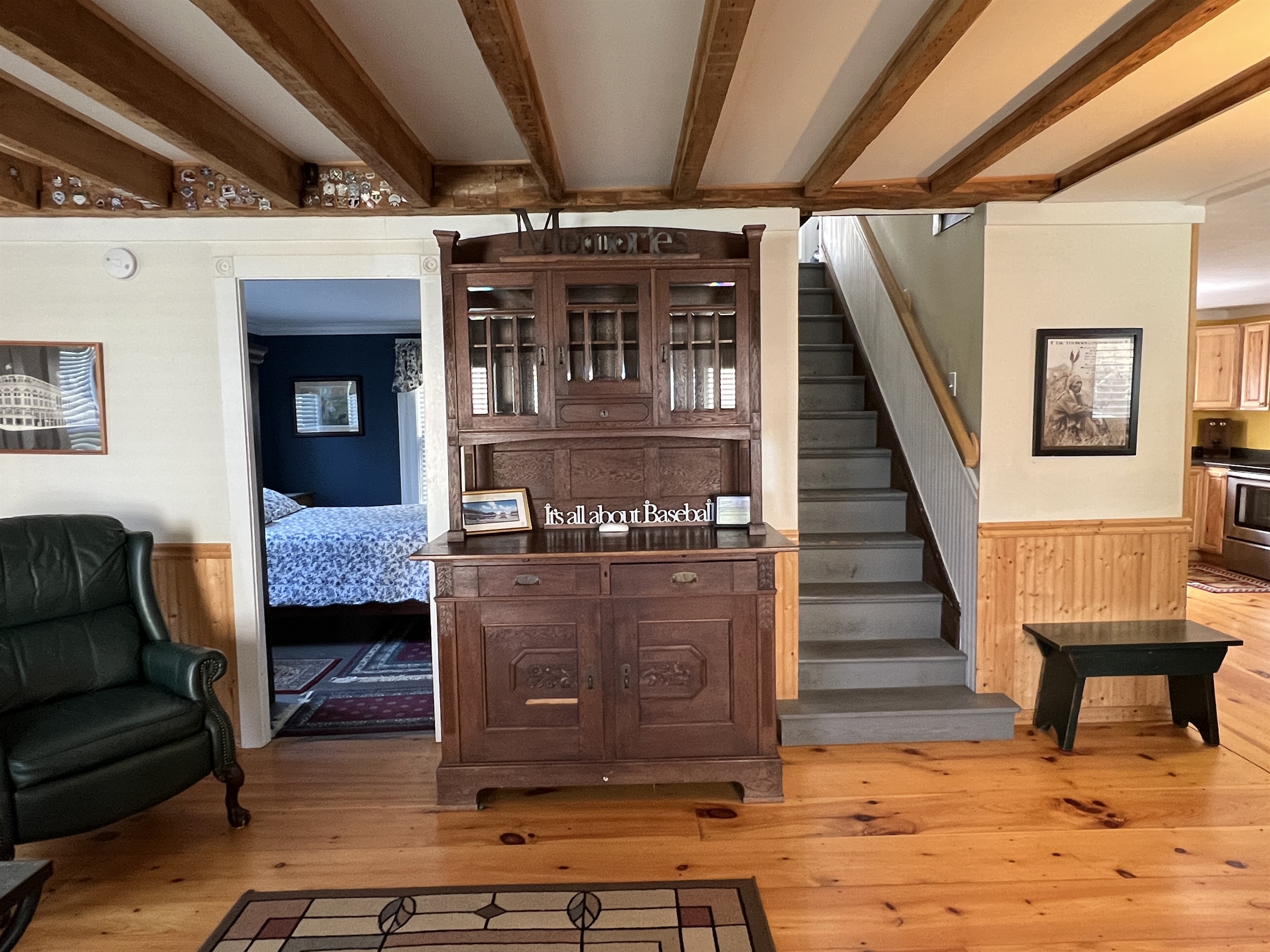 There is a nice open layout between the kitchen and living room. See the stairs here, leading to the 2nd floor and the 1st floor bedroom to the left.