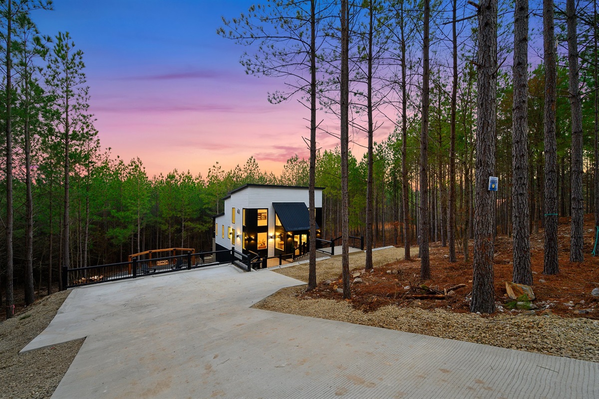 Modern architecture meets tranquil woodland surroundings.