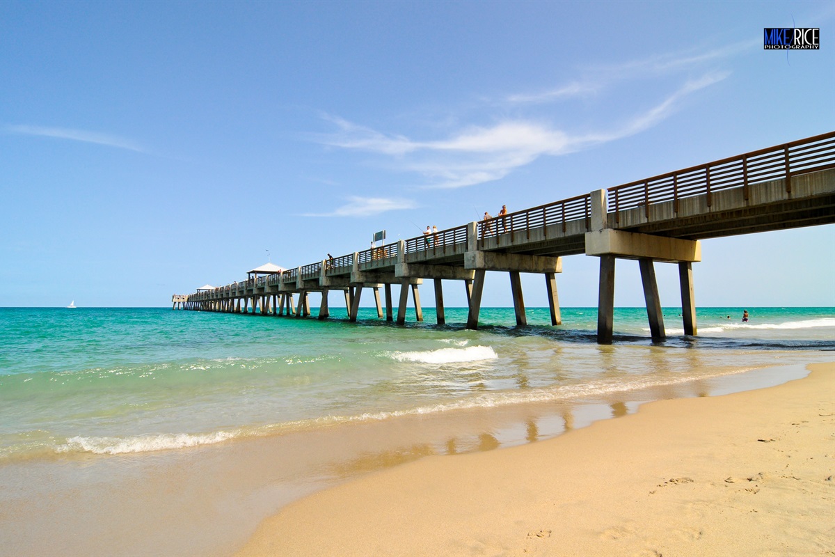The iconic Juno Beach Pier stretches gracefully over crystal-clear turquoise waters, inviting visitors to stroll above the waves, watch the sunrise, or cast a line - an unforgettable spot capturing the natural beauty of Florida's Atlantic East Coast.