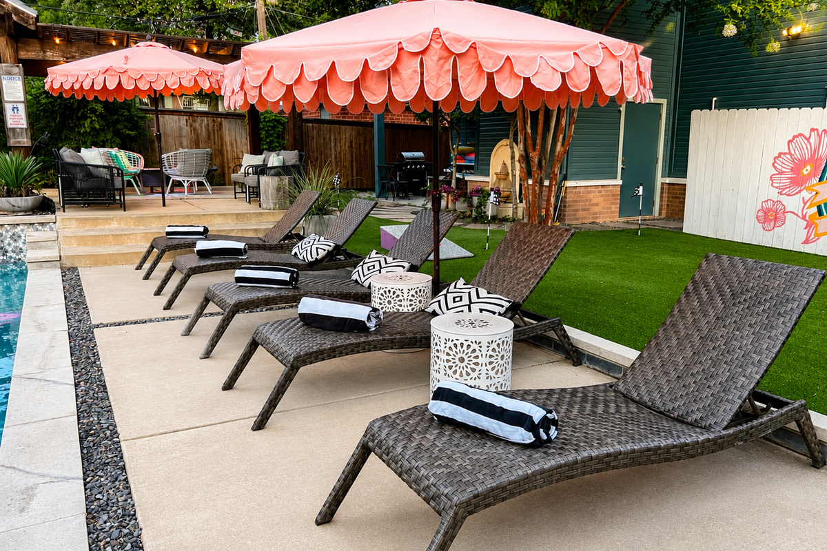 Pool loungers and umbrellas at The Style Studio, a Fort Worth private pool retreat.
