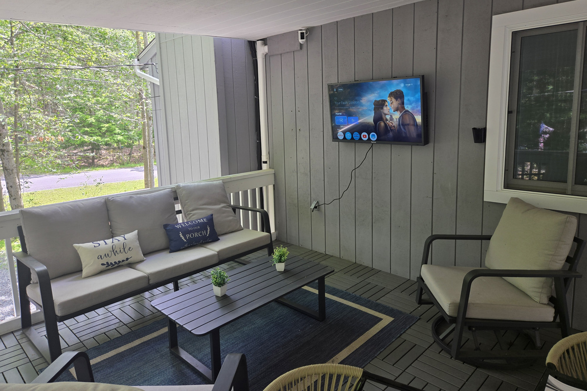 Unwind at the cozy outdoor table on the covered deck, perfect for enjoying a meal or morning coffee.