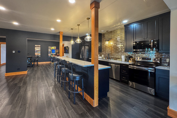 Downstairs kitchen with full-size appliances and bar seating.