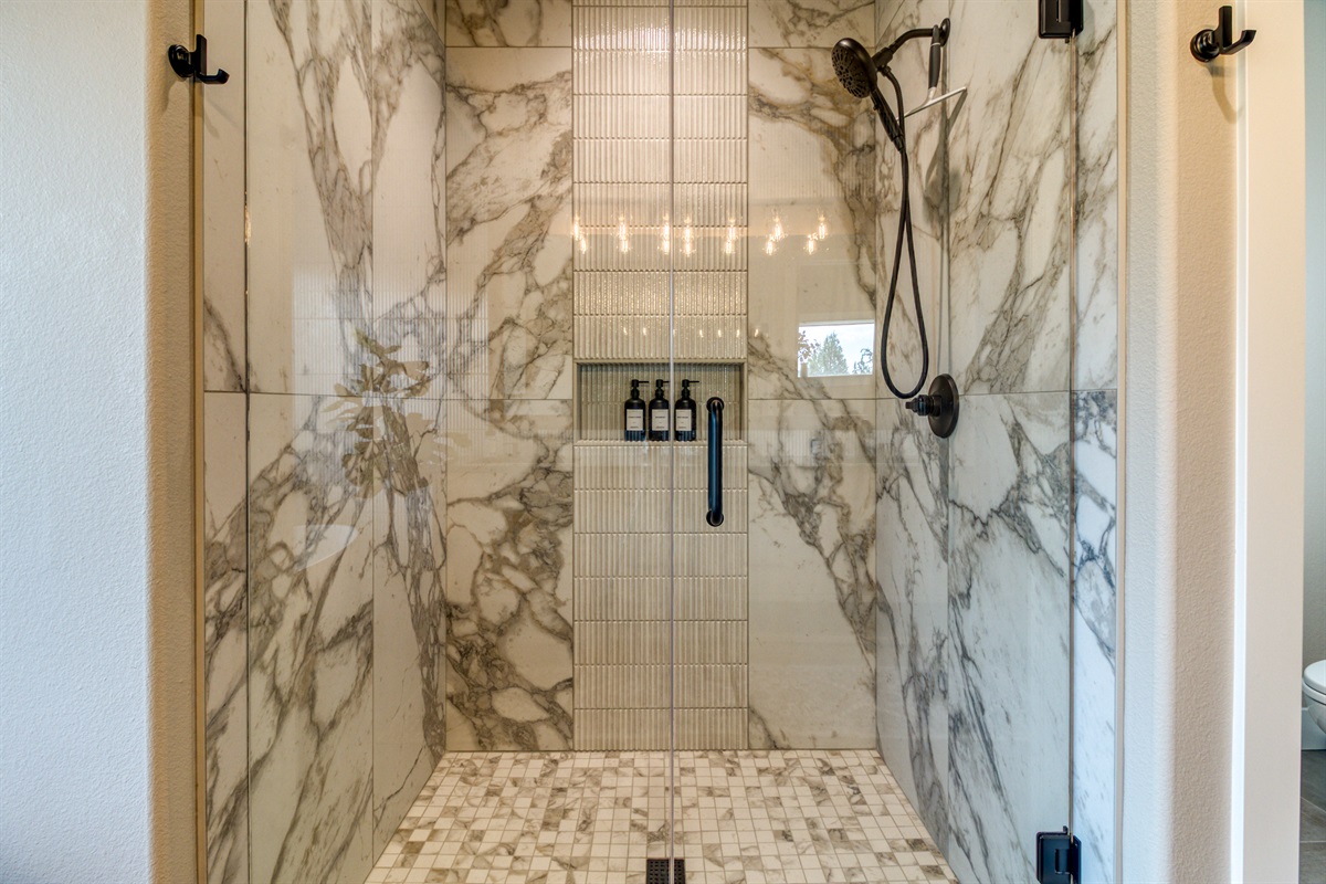 Huge walk-in glass shower with shampoo, conditioner & body wash.