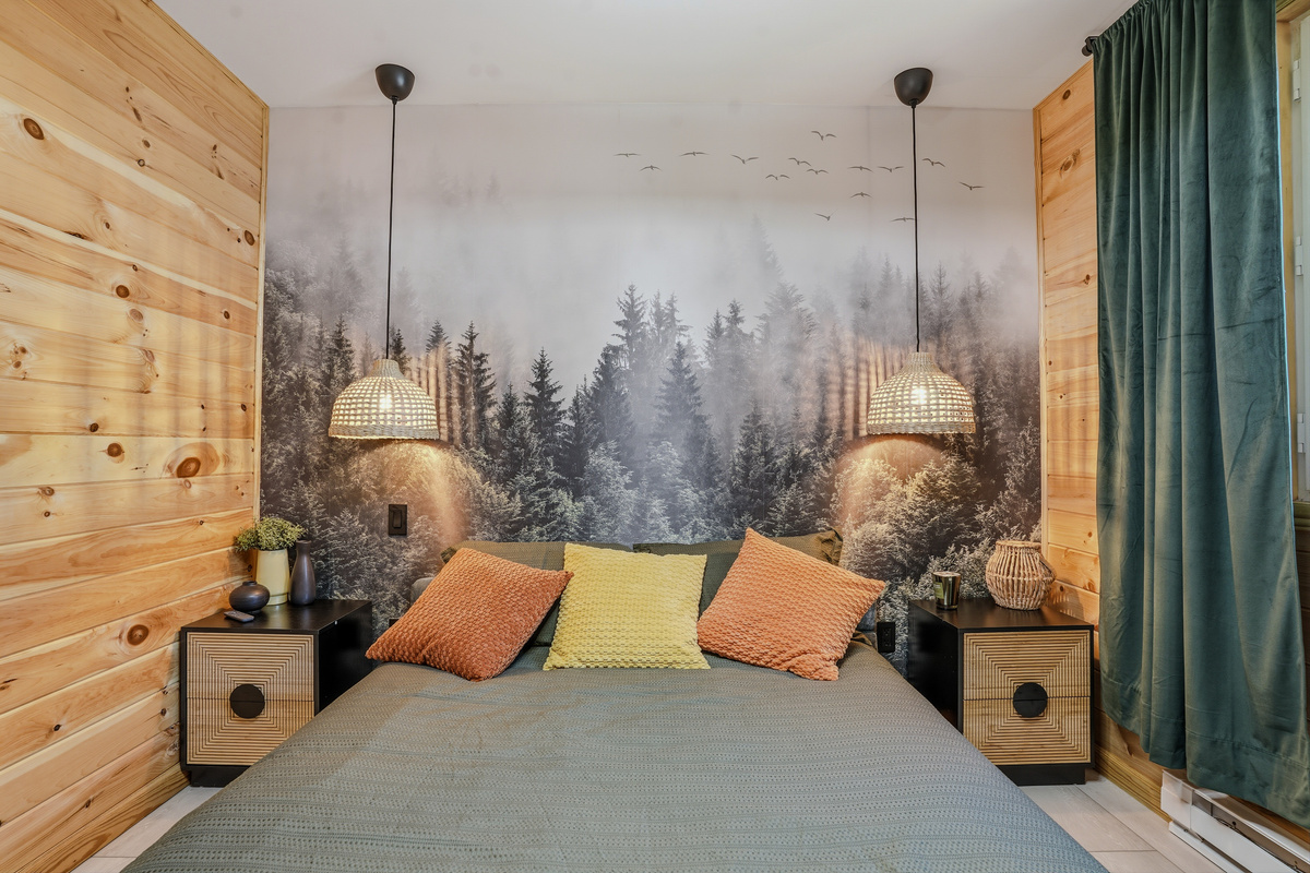 Queen bedroom — queen bed, forest mural feature wall, and carefully layered bedding