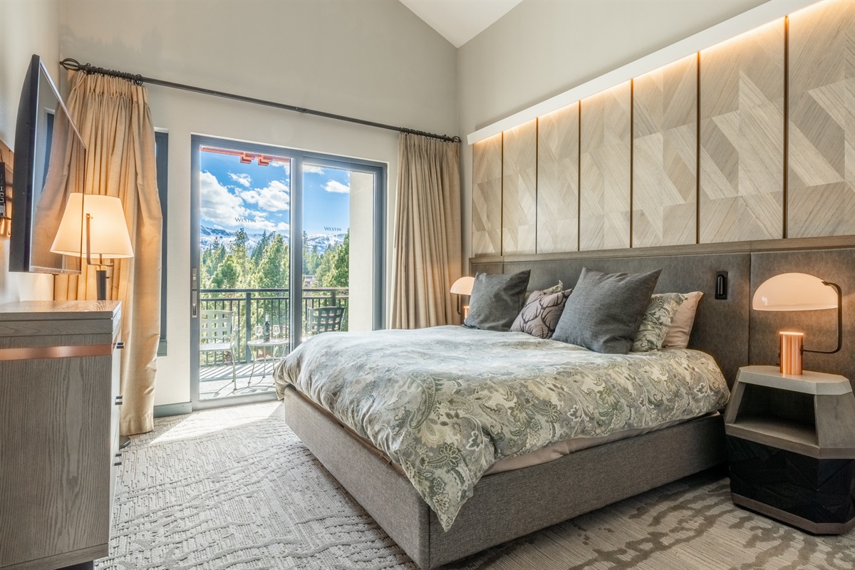A quiet king en-suite offers access to a private, south facing balcony, soft light, cozy bedding, and a restful, elevated feel.