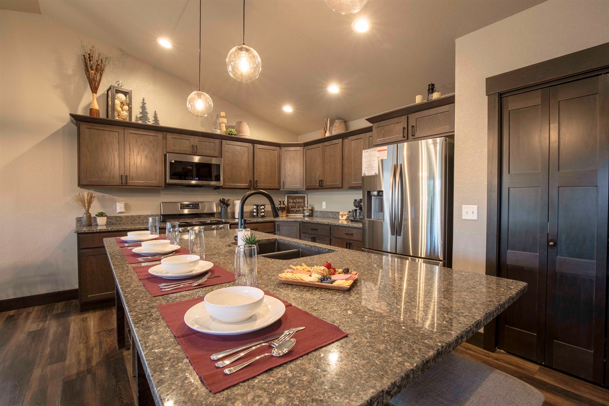 Picture yourself preparing meals in the sleek kitchen at "On The Rocks," surrounded by stainless steel appliances and a spacious granite island with bar stools.