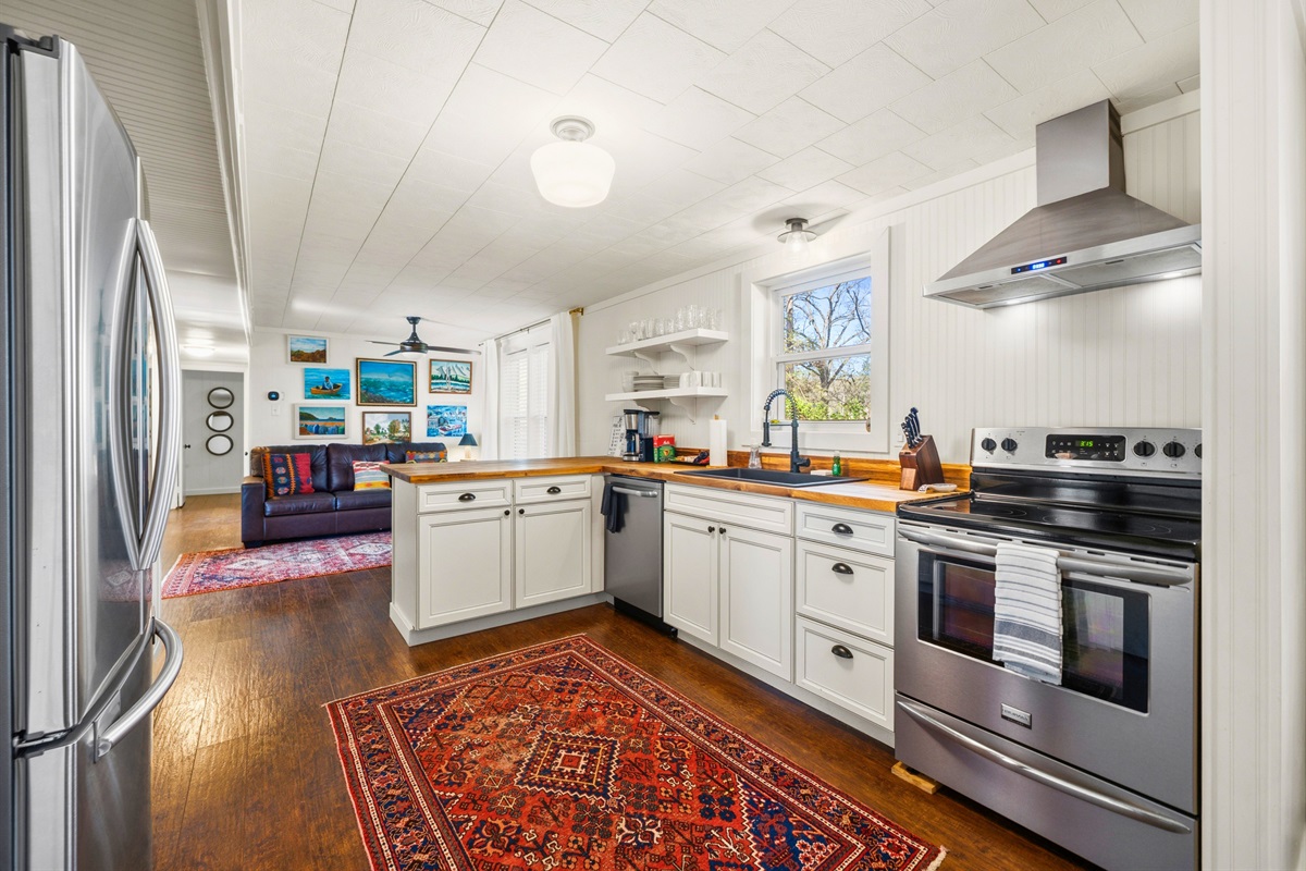 Cook with ease in the guest house kitchen where modern appliances, generous counter space, and a bright layout make meal prep simple and enjoyable.