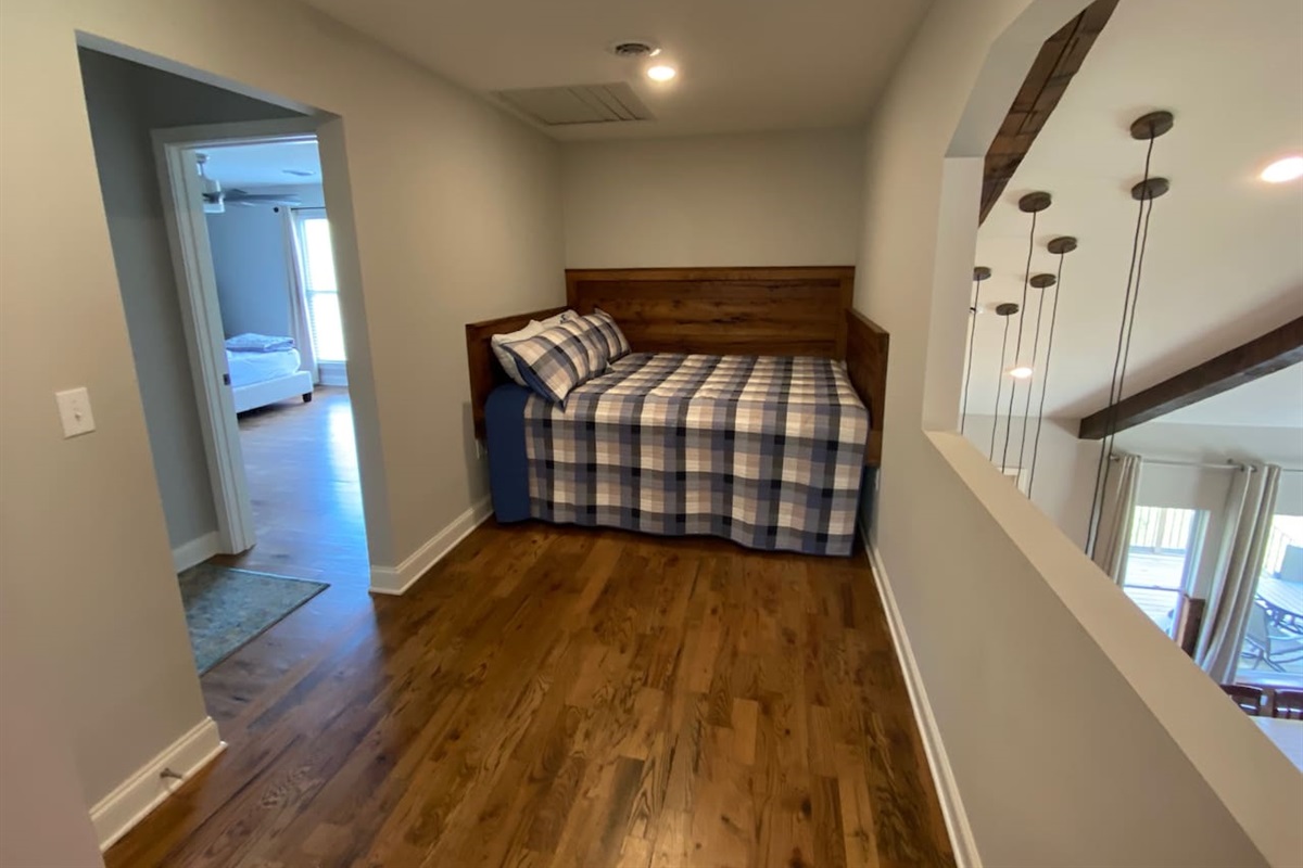 King loft bed outside of a king and queen bedroom upstairs.