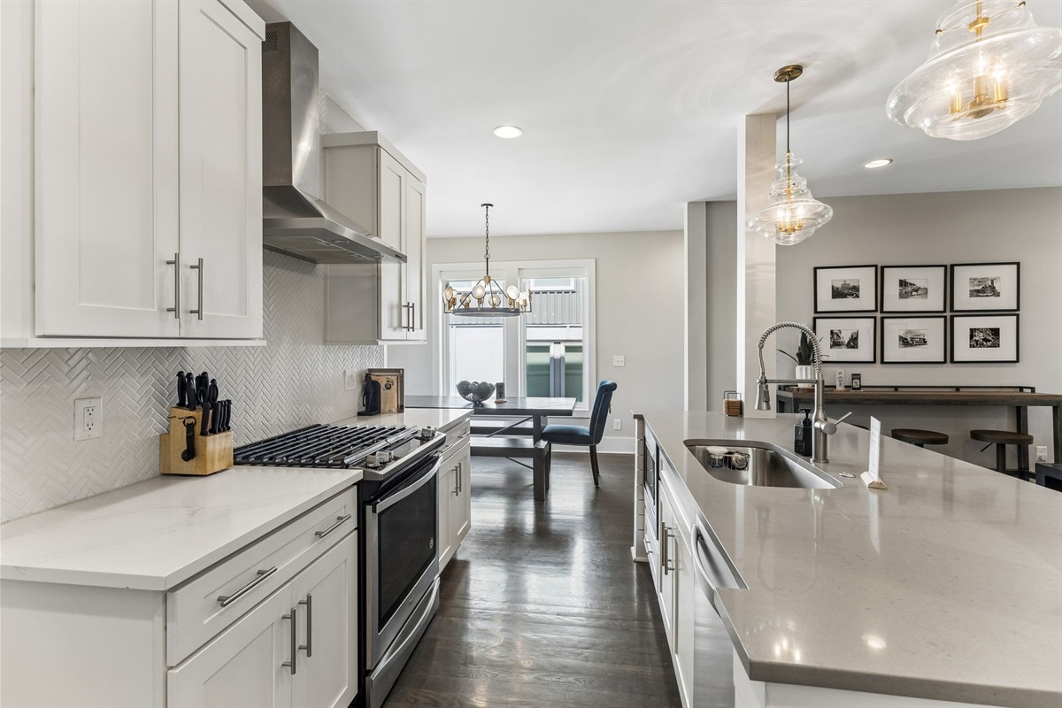 You've got a real gas range for whoever wants to cook &mdash; stainless steel burners, herringbone backsplash, and a kitchen that doesn't make you feel like you're roughing it.