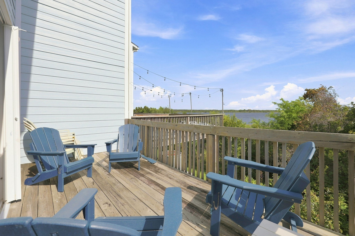 Take in stunning open-water views and string-lit evenings from the comfort of this spacious, blue-accented deck.