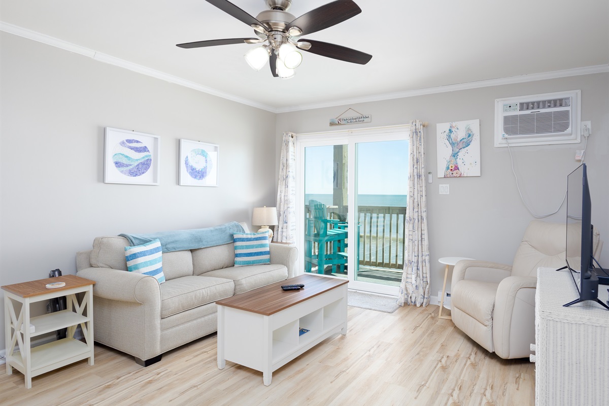 Spacious living room with natural light and balcony access