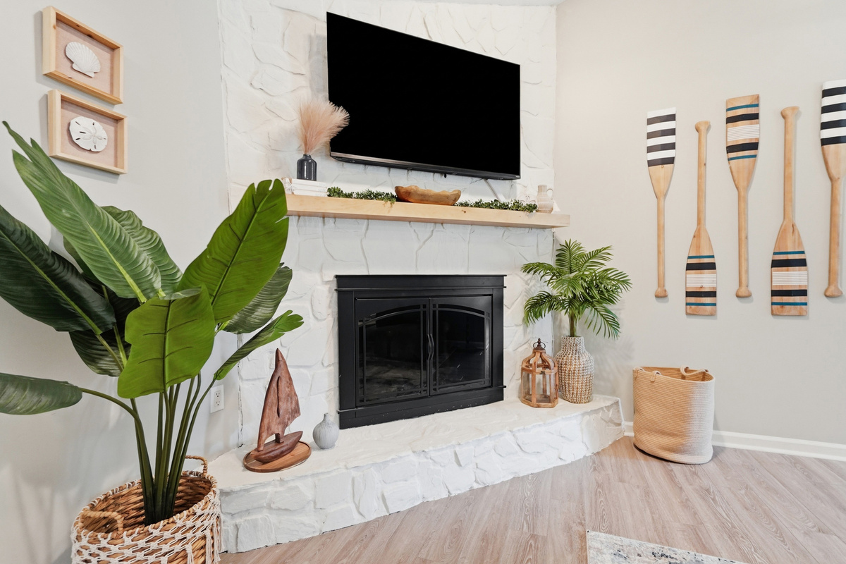 A large mounted TV and fireplace create the perfect setup for laid-back movie nights.