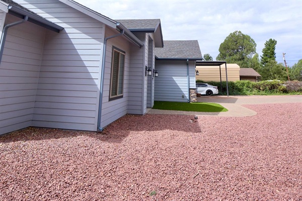 front entrance with driveway and covered parking