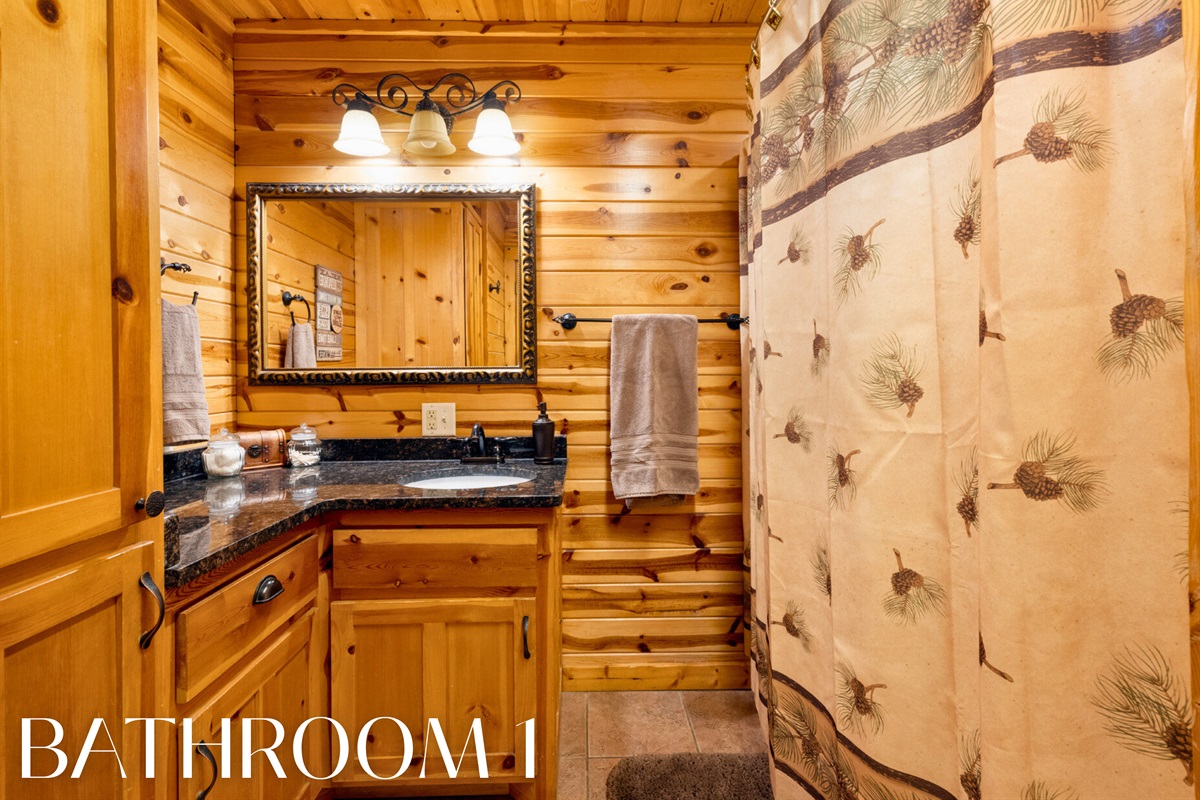 Bathroom 1 with rustic finishes and shower/tub combo.
