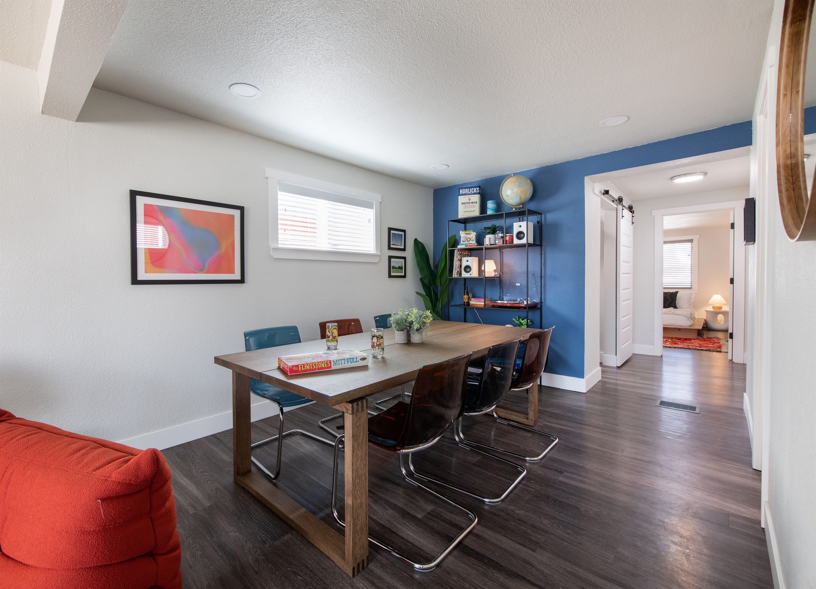 View of bedroom 2 from dining area and upper living room edge looking to back of house from the front