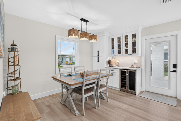 The light-filled dining area offers comfortable seating for four beside the kitchen.

