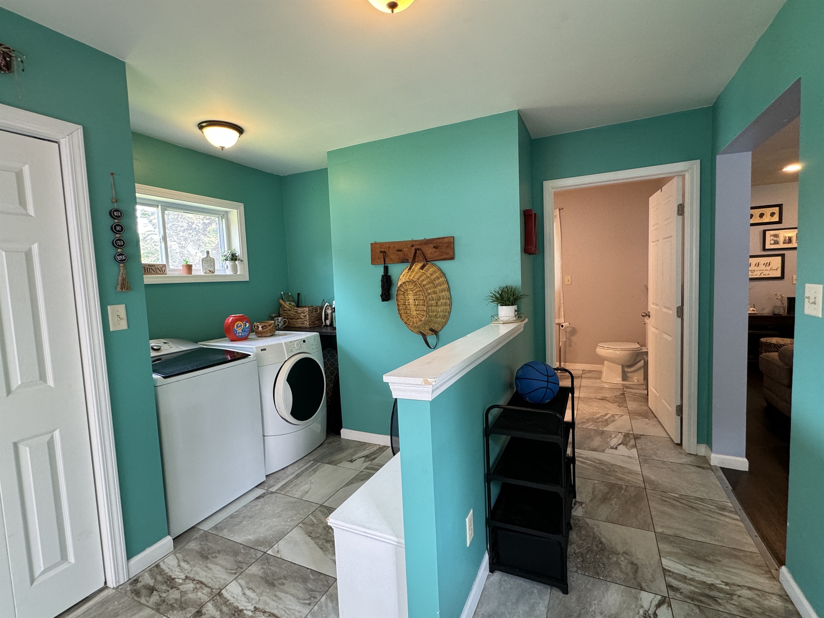 Mudroom entry and laundry area, full bathroom to the right.