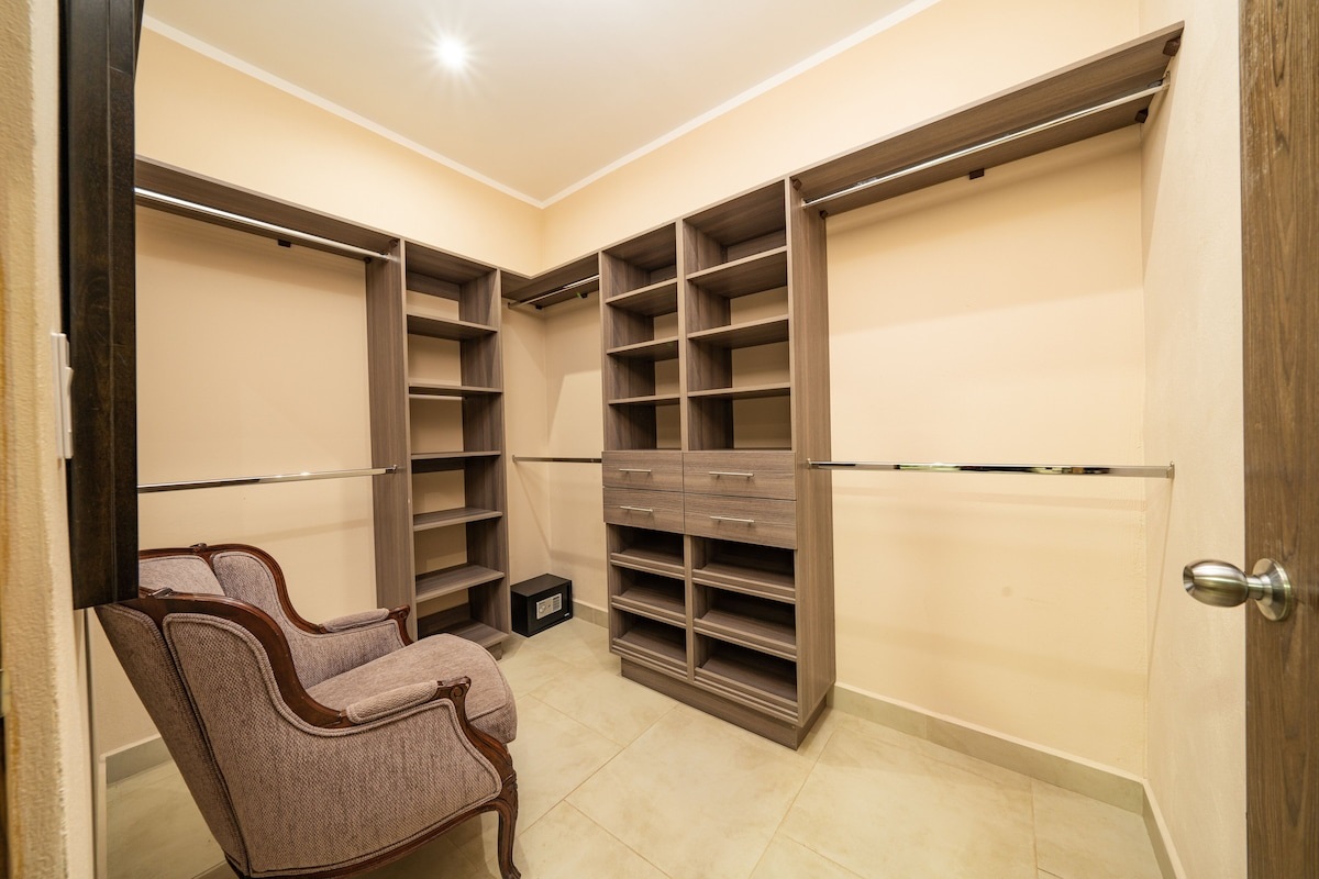 Walk-in closet with a safe for guest use