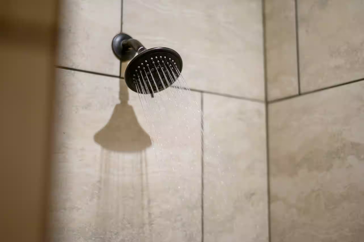 Shower Oasis: Refresh under a modern rainfall showerhead in this stunning tiled bathroom retreat!