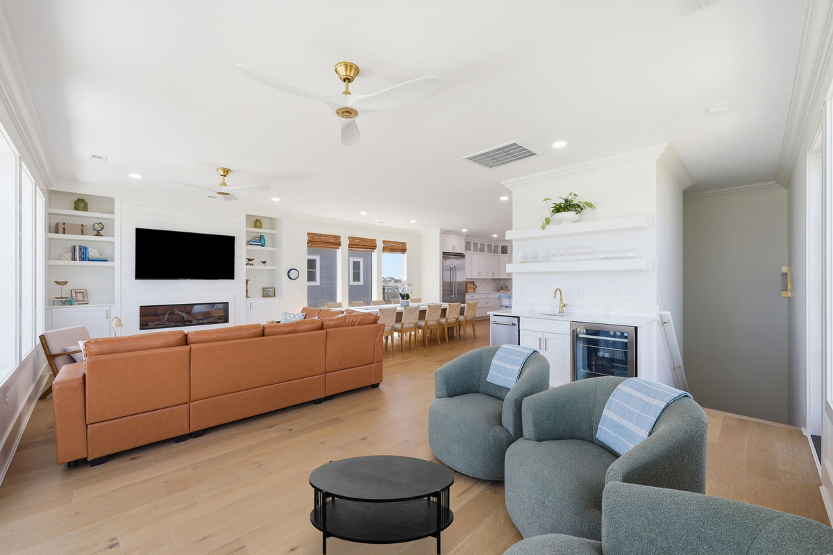Spacious open-concept living, dining, and kitchen area designed for effortless group gatherings with seamless ocean views and natural light throughout