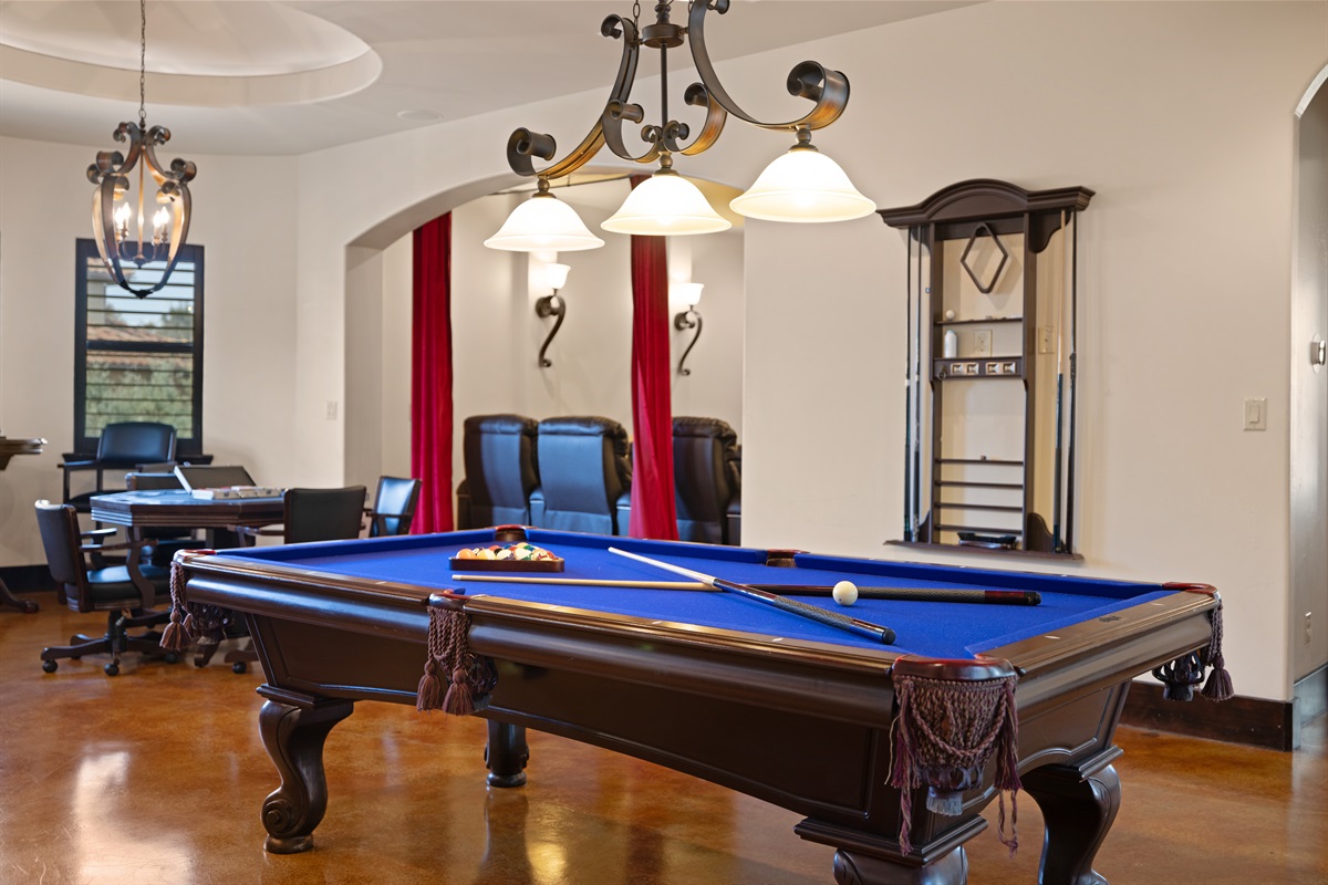 Where fun meets style – the ultimate adult game room, complete with a bar, pool table, poker table, and media room for endless entertainment.