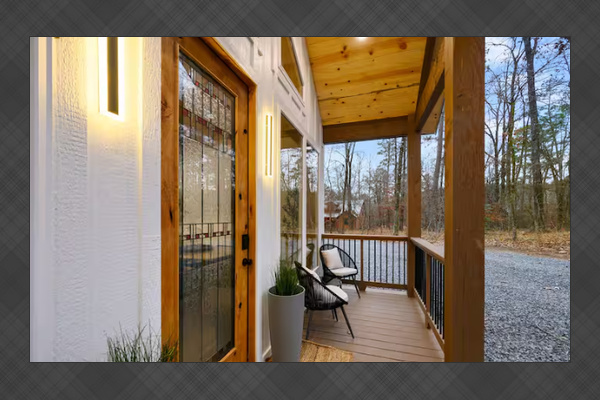 Covered front porch with peaceful woodland views