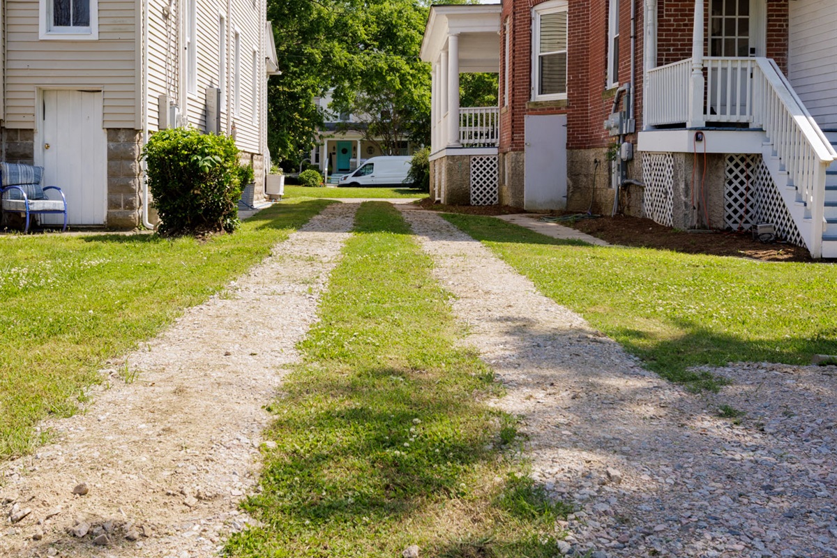 Driveway offers this unit parking and easy access to parking behind the unit's side of the home.